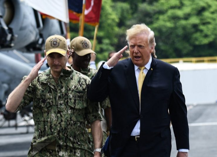 US President Donald Trump (R) salutes as he arrives aboard the amphibious assault ship USS Wasp (LHD 1) to participate in a Memorial Day event in Yokosuka on May 28, 2019. (Photo by Brendan SMIALOWSKI / AFP)        (Photo credit should read BRENDAN SMIALOWSKI/AFP/Getty Images)